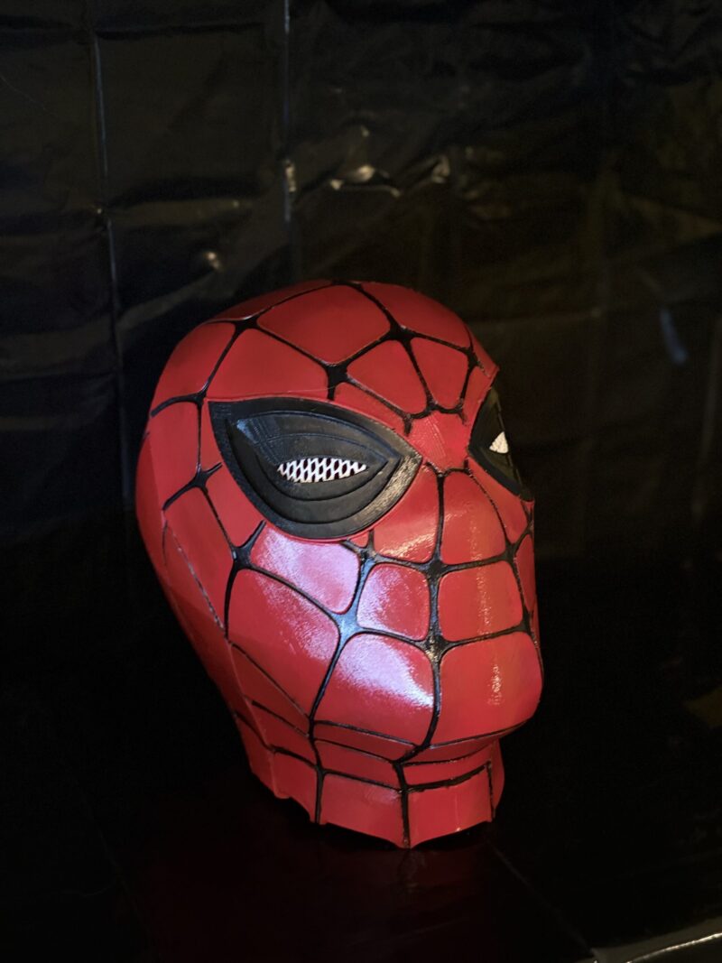 3D printed Spider Hero mask with red surface and black web pattern inspired by Spider-Man.