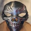 3D printed metallic skull mask with battle scars and red blood splatter details